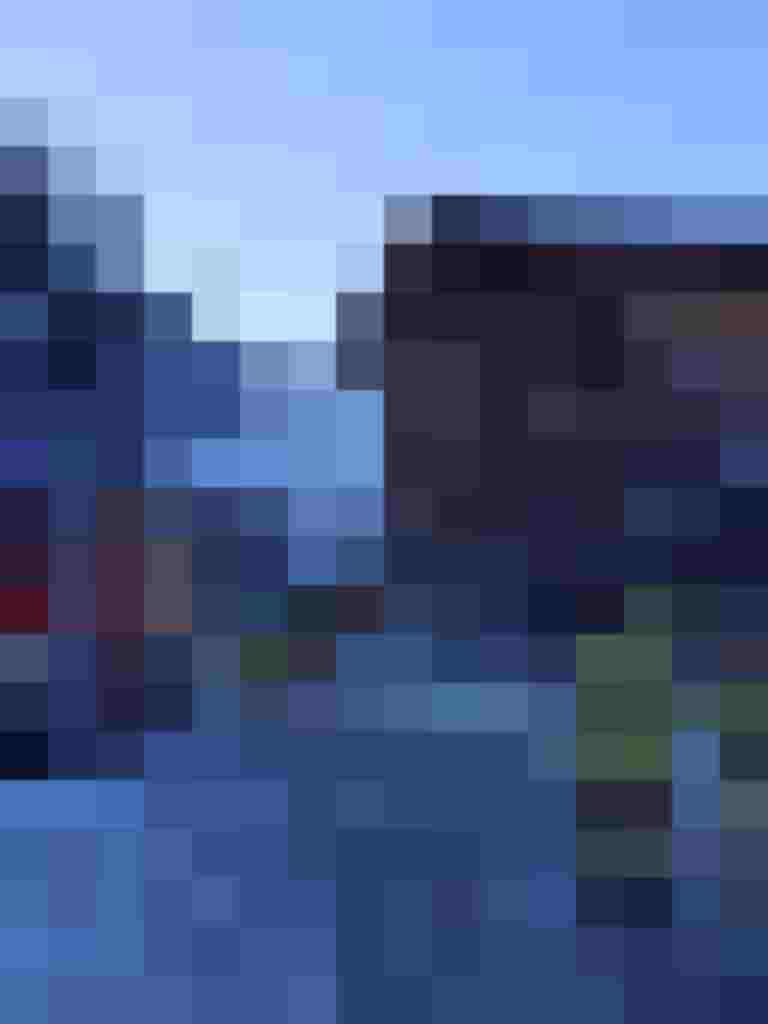 Feuerwehrkräfte arbeiten vor einem rauchenden Hotelgebäude in verschneiter Umgebung