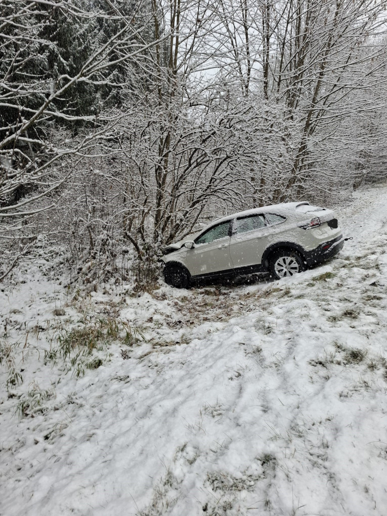 PKW rutscht bei Schneefall von der Straße in ein Waldstück und kommt vor Bäumen zum